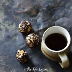 3 chocolate peanut butter protein bites with a cup of coffee