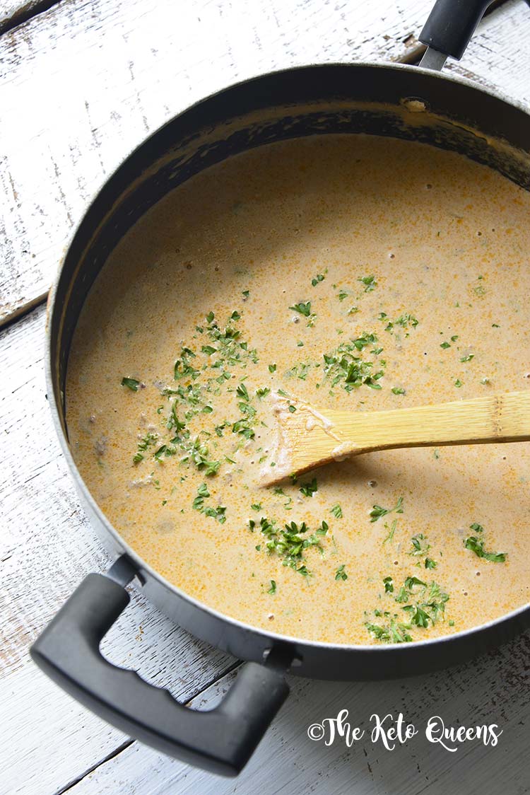 Keto Bacon Cheeseburger Soup in a pot with a wooden spoon