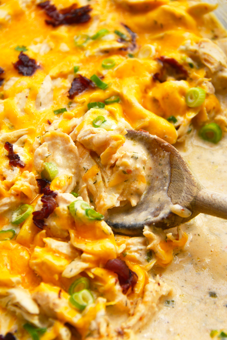 fully baked chicken topped with shredded cheddar cheese, bacon, and scallions