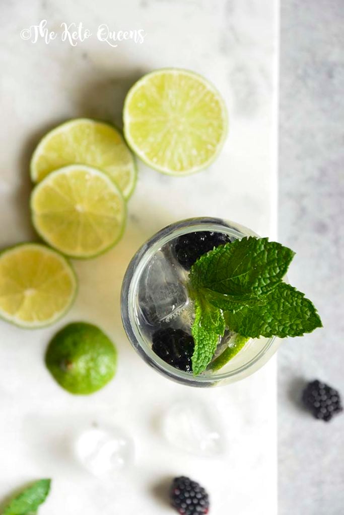 Blackberry Mojito Mocktail recipe in a clear glass garnished with mint, lime and blackberries