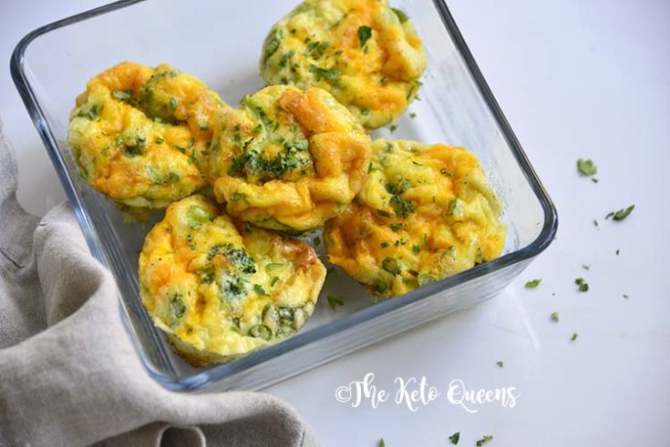 horizontal image of broccoli and cheddar egg muffins in a glass storage container with a napkin
