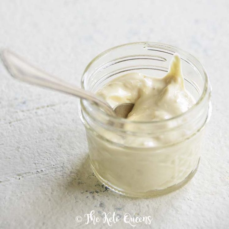 featured image of creamy caesar salad dressing in a glass mason jar with a spoon on a white surface