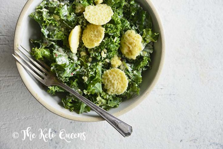 horizontal image of a caesar salad in a white bowl on a white surface