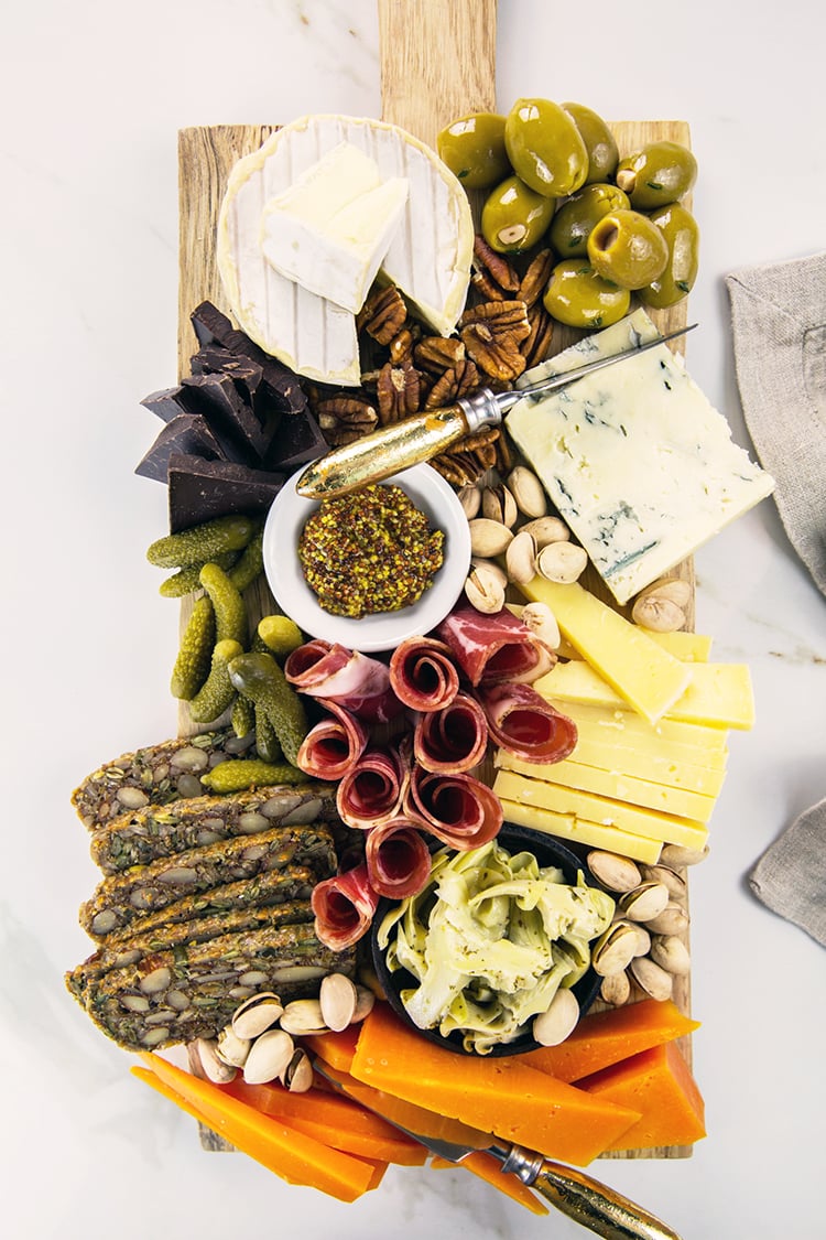 Cheese Board on Wooden Board with White Marble Background