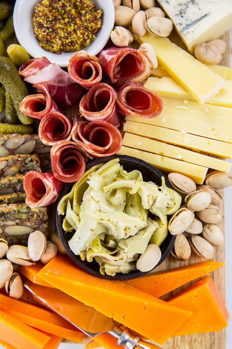 Close Up of Cheese Board with Marinated Artichoke Hearts