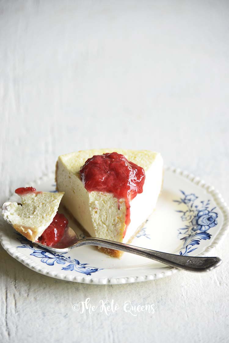 low carb instant pot cheese cake with easy strawberry sauce on a white background