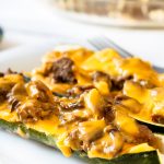 slow cooker BBQ brisket stuffed zucchini boats on a white plate