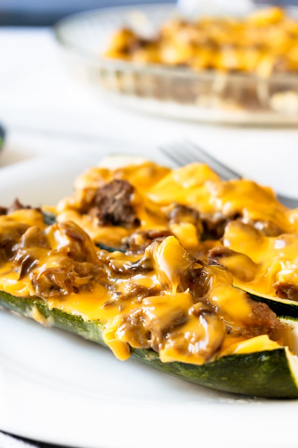 slow cooker BBQ brisket stuffed zucchini boats on a white plate