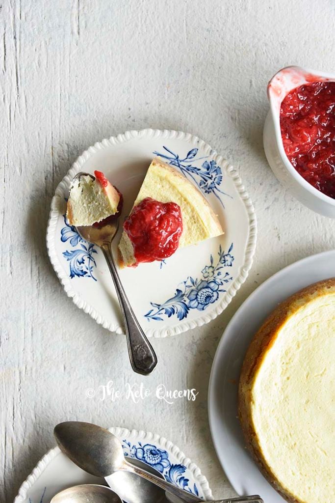 low carb instant pot cheese cake with easy strawberry sauce on a white background