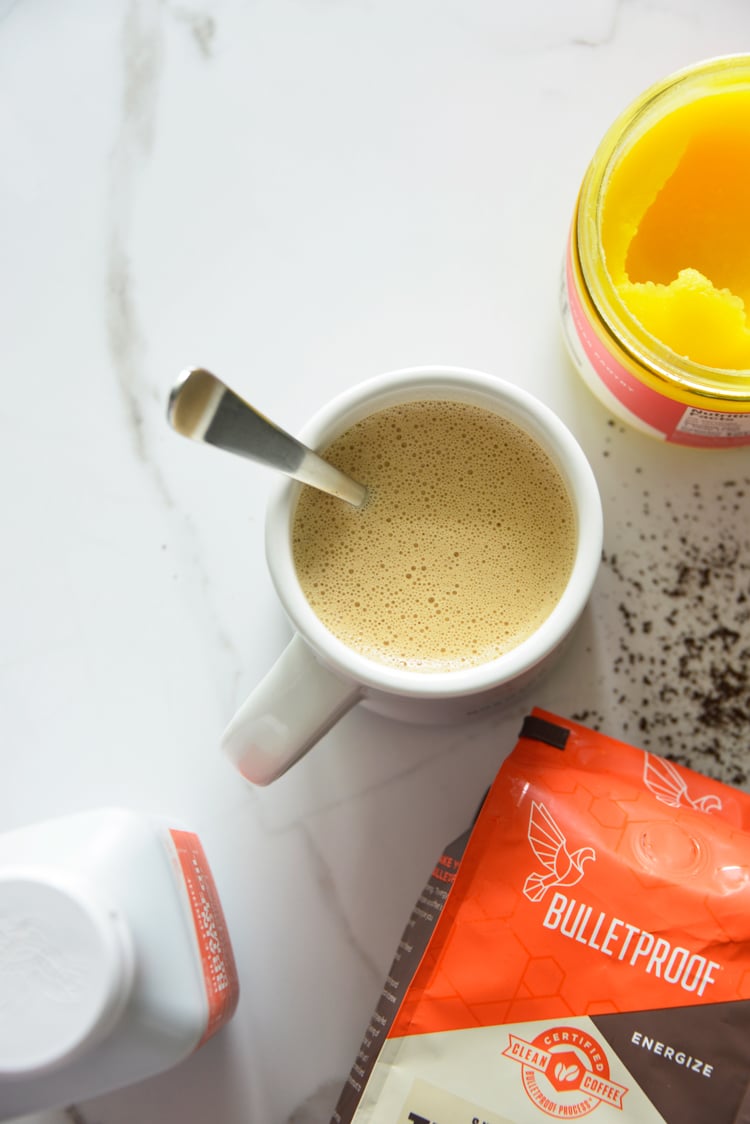 image of bulletproof coffee in a white mug with a spoon and ghee
