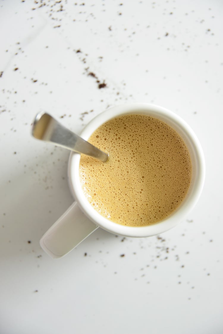 image of bulletproof coffee in a white mug with a spoon