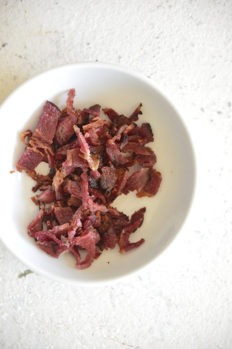 image of crisp and crumbled bacon in a white bowl
