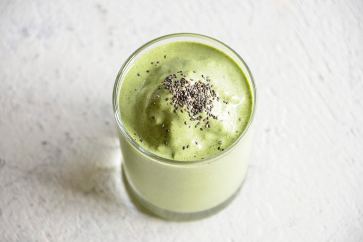Keto Protein Green Smoothie in a clear glass with chia seeds on top
