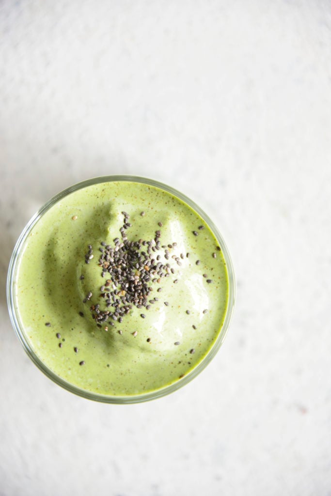 Keto Protein Green Smoothie in a clear glass with chia seeds on top