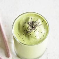 Keto Protein Green Smoothie in a clear glass with chia seeds on top