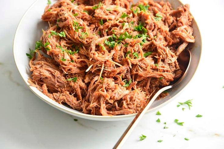 keto bbq pulled pork on a white bowl with parsley