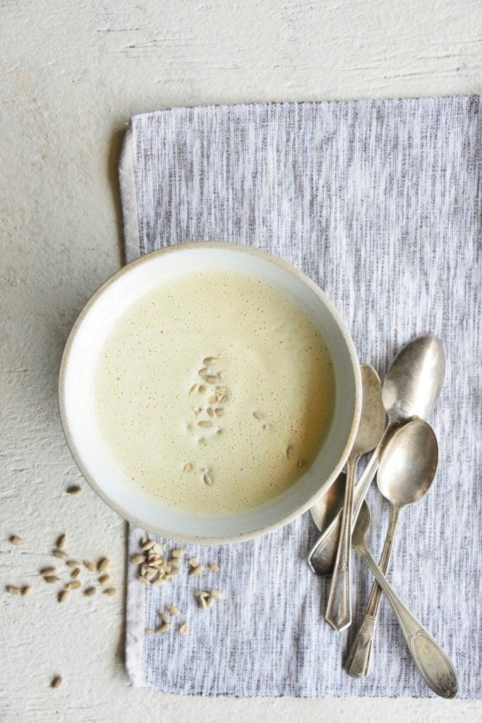Instant pot cream of broccoli stalk soup in a white bowl with spoons