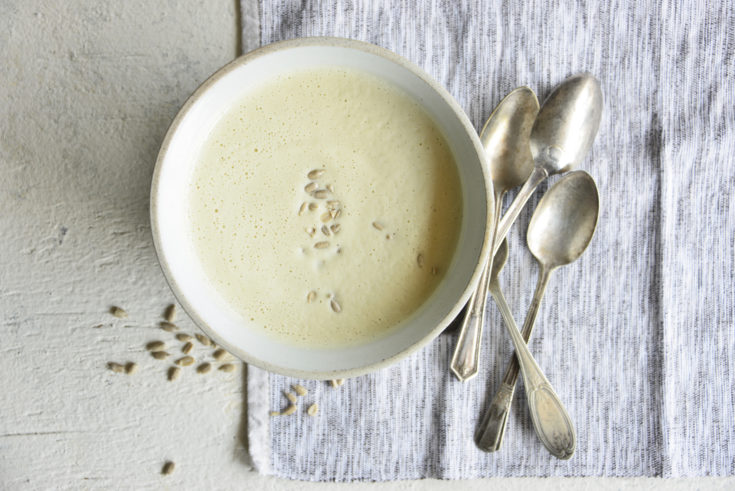 Instant pot cream of broccoli stalk soup in a white bowl with spoons