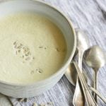 Instant pot cream of broccoli stalk soup in a white bowl with spoons