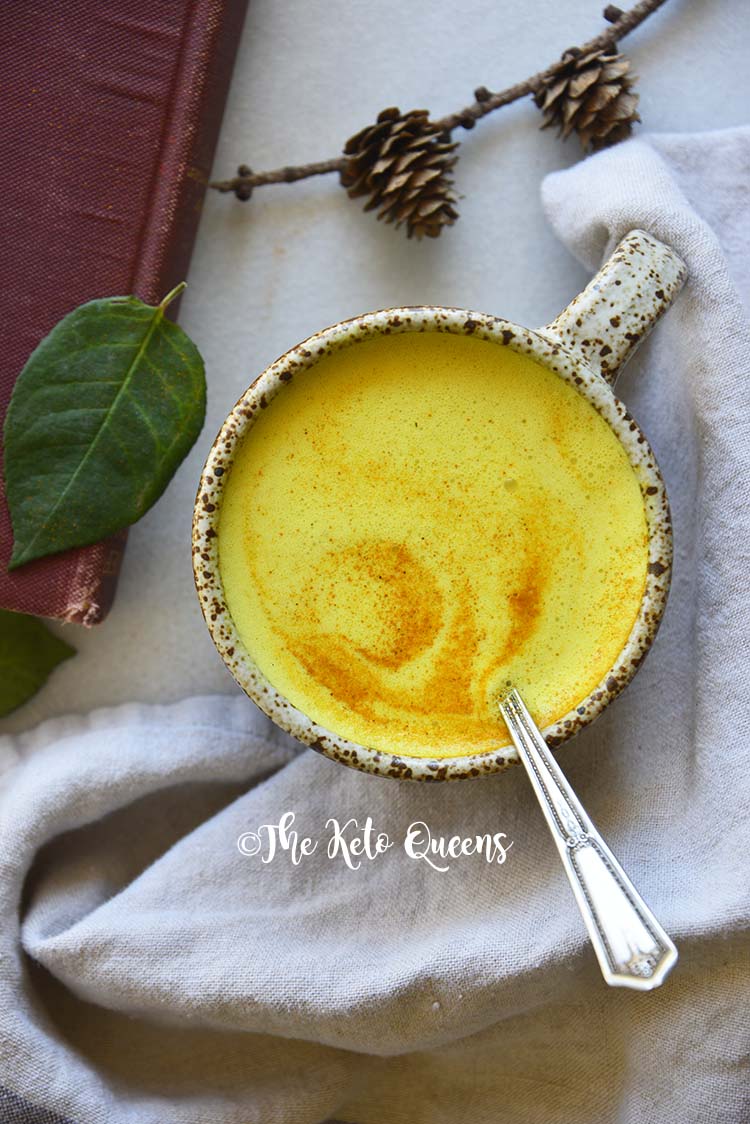 Top View of Golden Milk on Marble Counter with Red Book