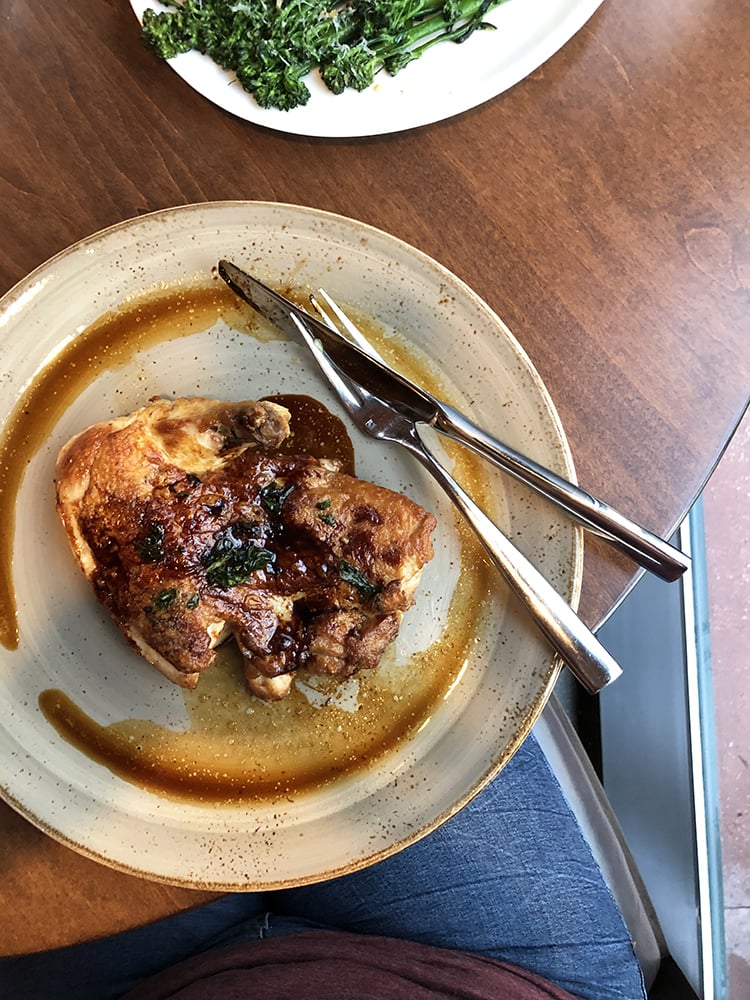 Top View of Half Chicken and Broccolini at Wolfgang Pucks