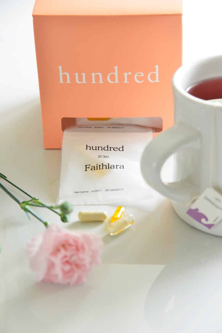 image of hundred vitamins with carnations and a cup of tea