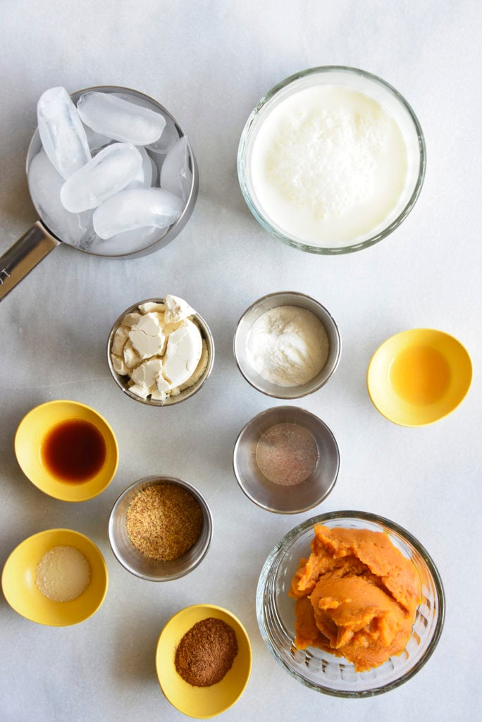 keto pumpkin smoothie ingredients on a white counter top