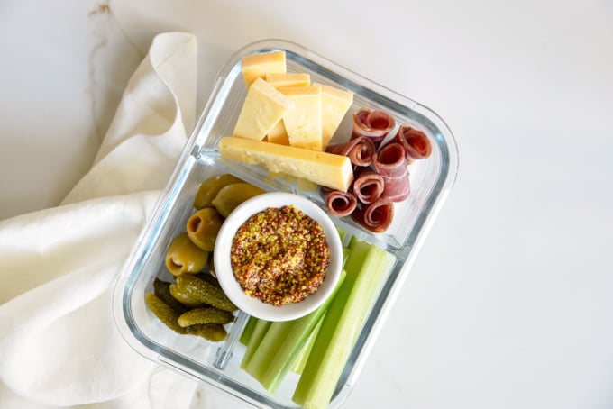Charcuterie and cheese is a quick and easy keto meal prep idea! Pack some charcuterie meats, cheese, pickles, olives, and celery in your favorite meal prep container. It'll make for a delicious, grab and grow lunch.
