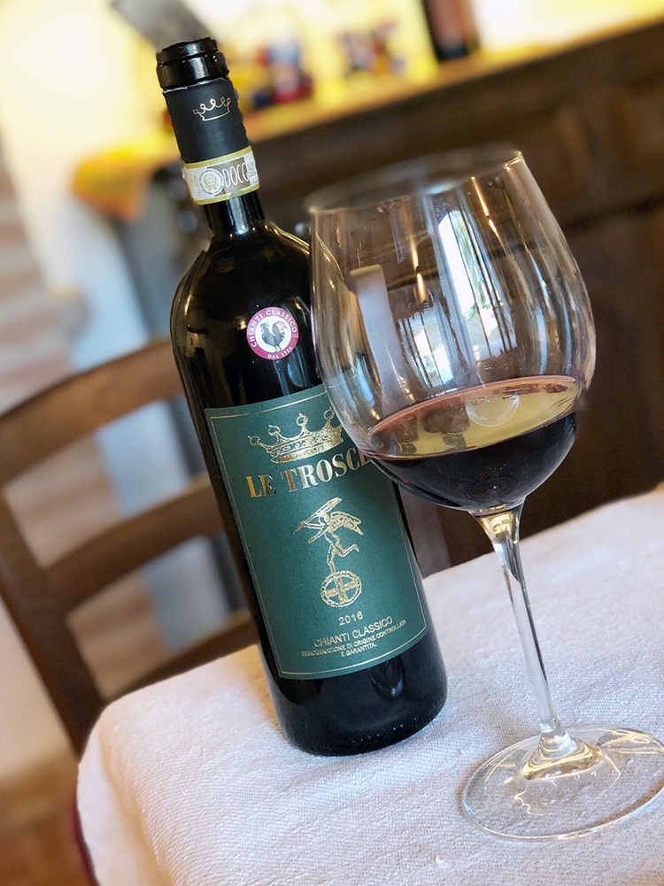 Le Trosce Wine Bottle with Glass of Wine