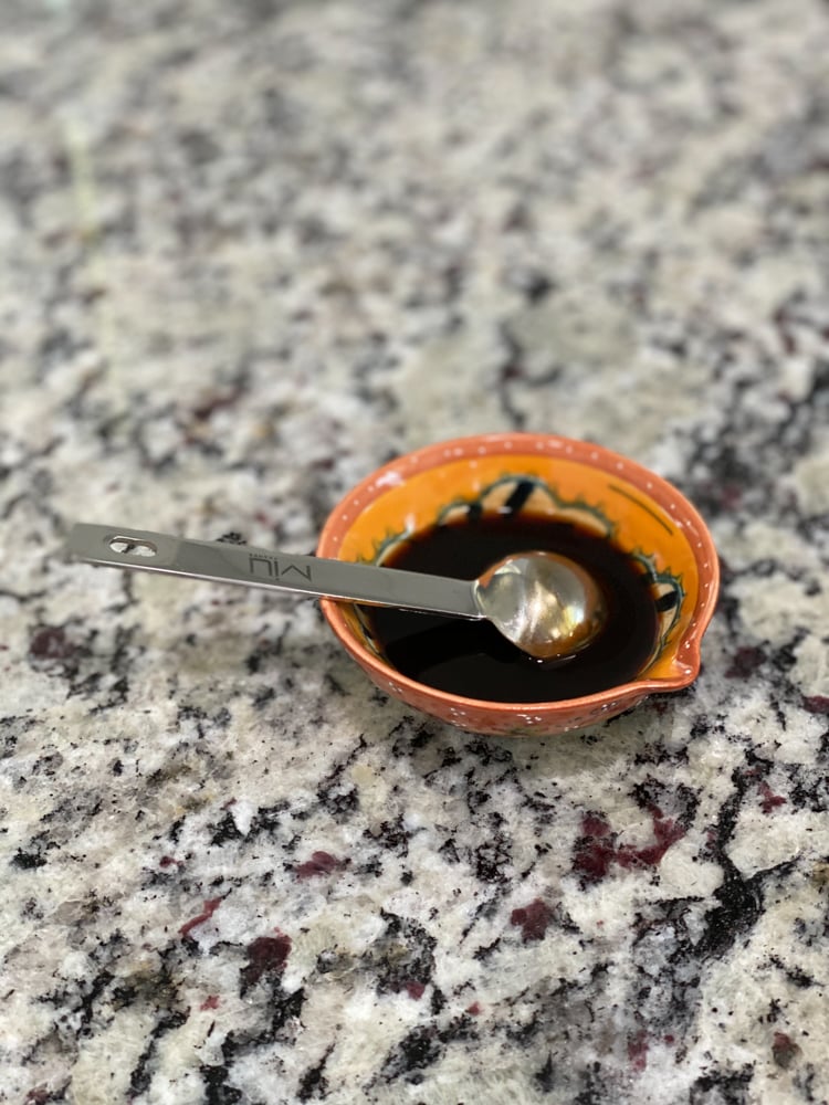 liquid in small bowl with measuring spoon