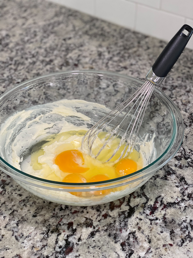 eggs in a glass bowl with a whisk