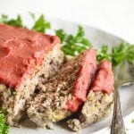 pressure cooker meatloaf recipe on a white plate with parsley
