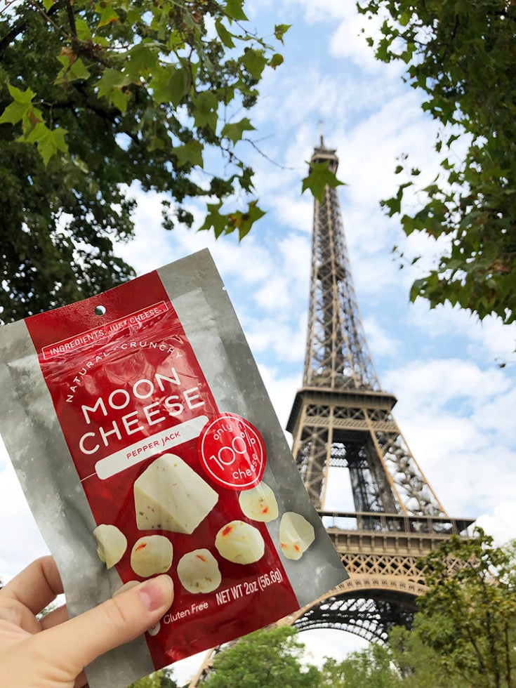 Moon Cheese pepper jack cheese a keto travel snack in front of the Eiffel Tower in Paris