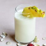 keto pina colada in a glass cup with pineapple and cherry