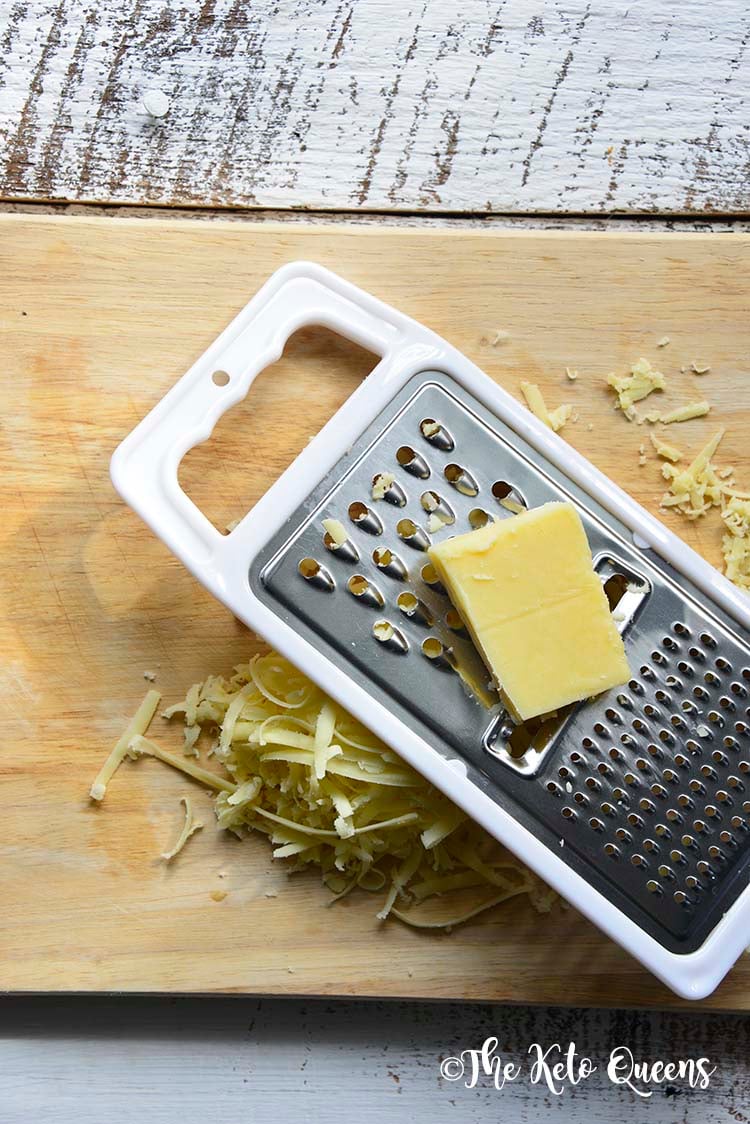 white organic valley block cheese being shredded