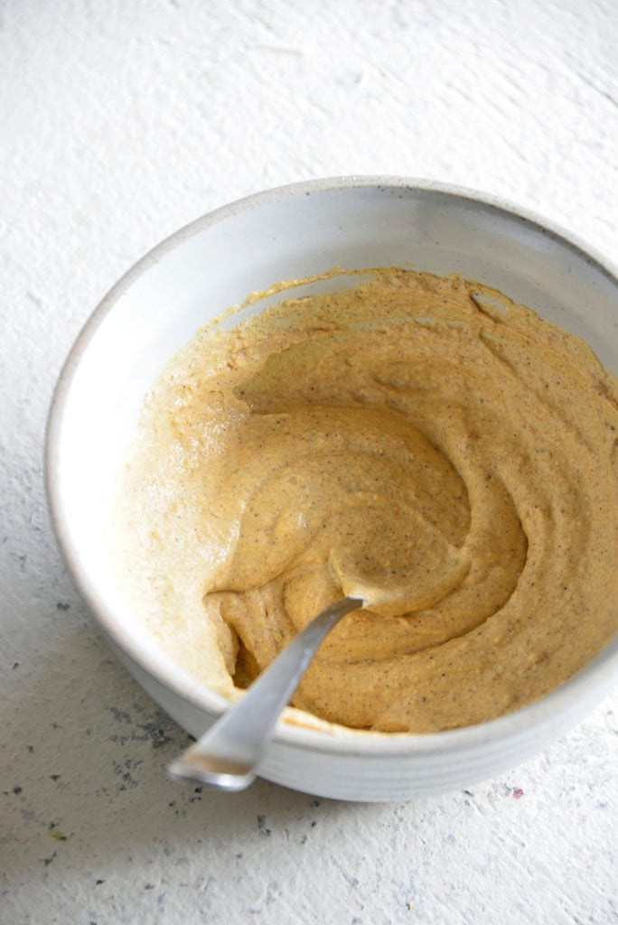 Keto Pumpkin Spice Cream Cheese Fat Bombs ingredients in a white bowl