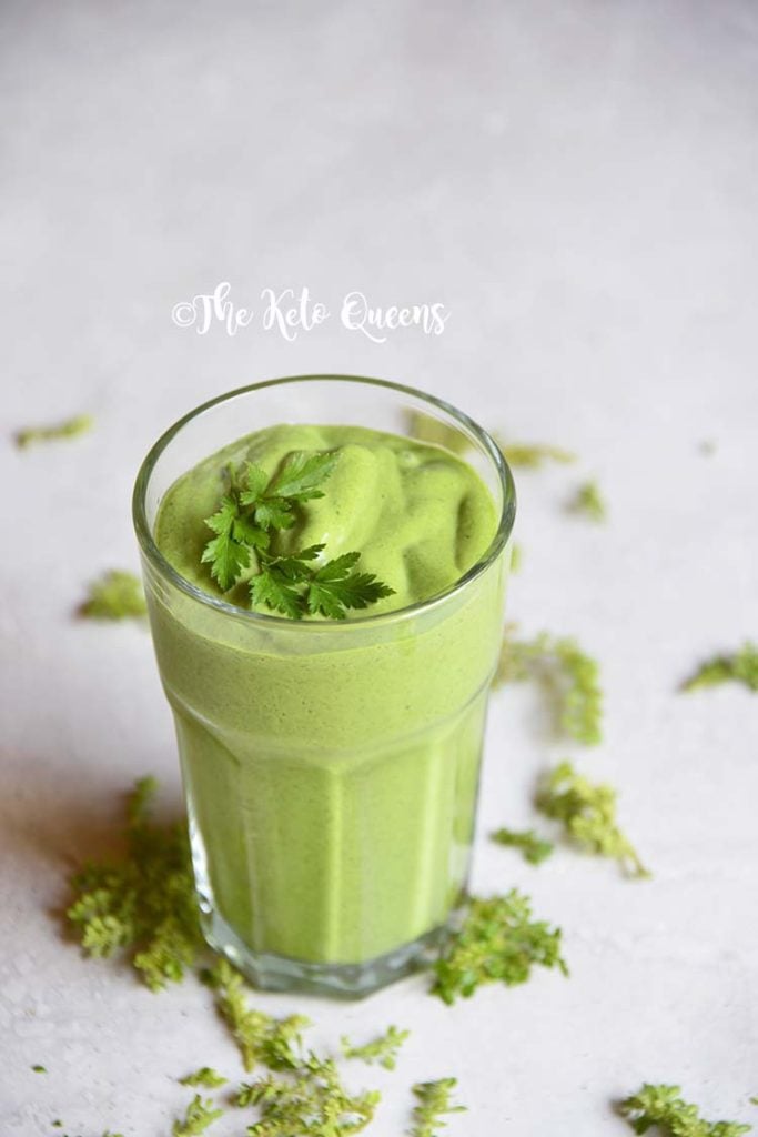 detox keto green smoothie in a clear cup with parsley on top