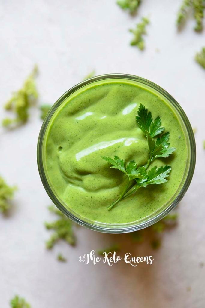 detox keto green smoothie in a clear cup with parsley on top