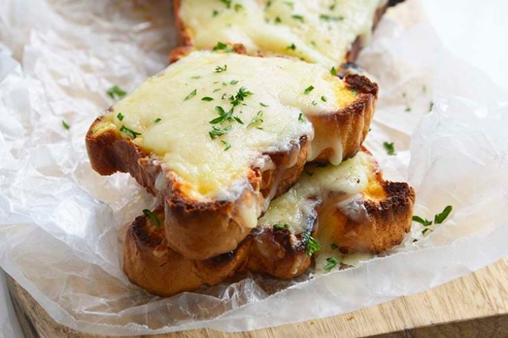 close up image of low carb Texas toast on a parchment paper topped with parsley