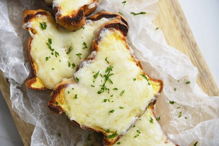 low carb Texas toast on a parchment paper topped with parsley